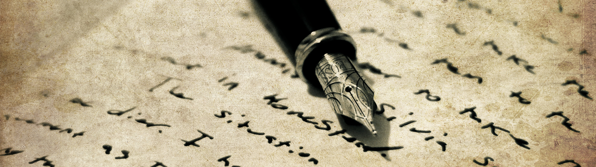 Photo of a pen and writing on a page.